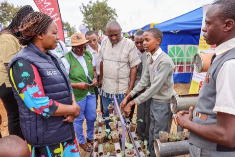 Students showing a vertical growing system